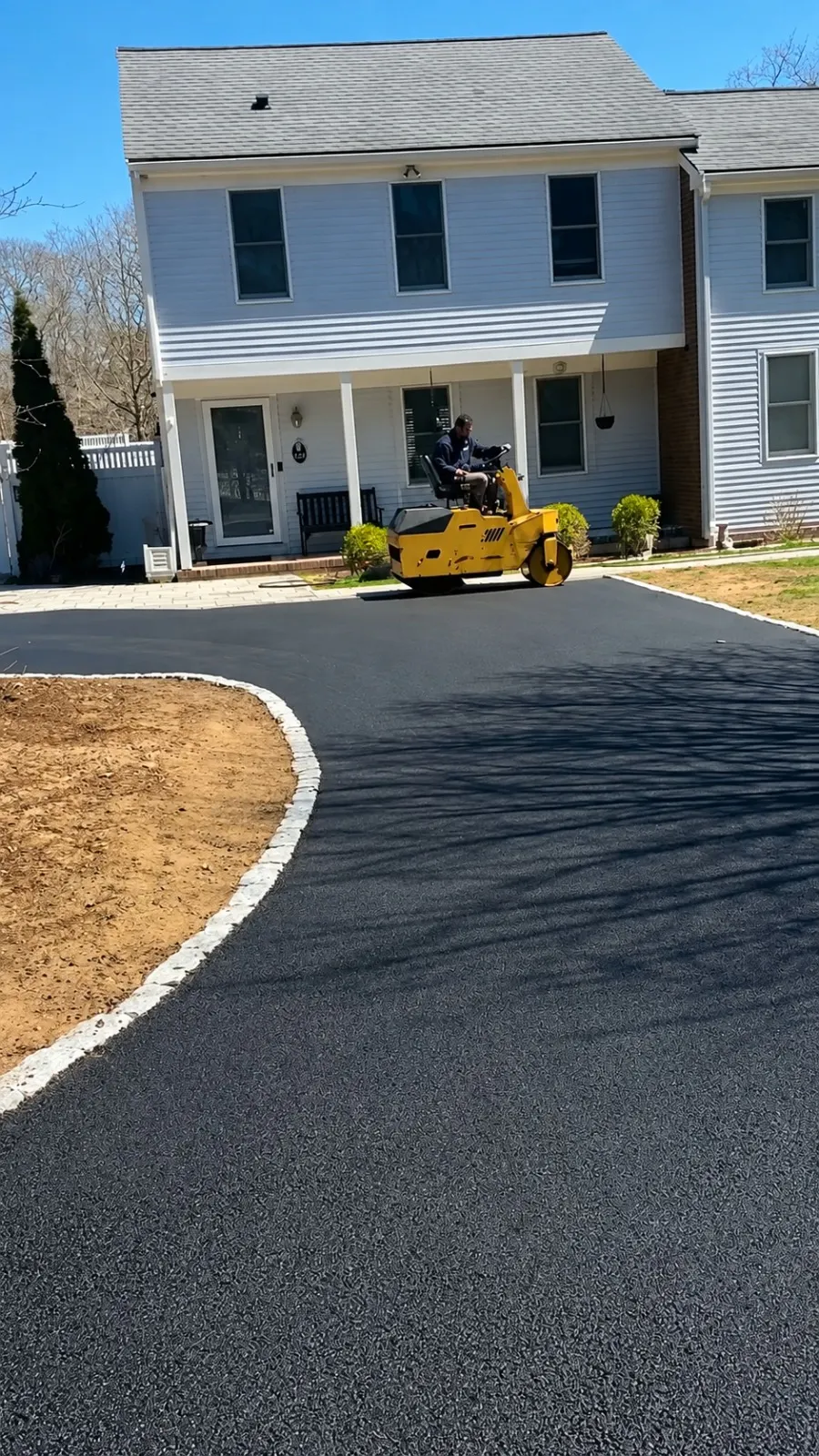RS Superior operator compacting a new residential asphalt driveway